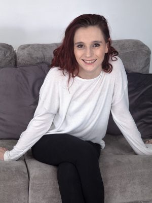 Lily May strips naked on her grey sofa today